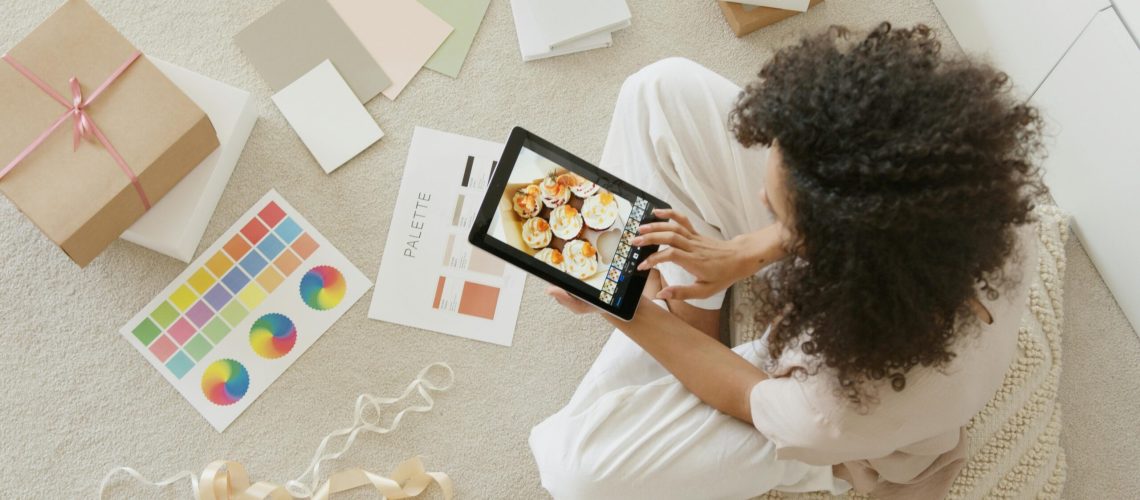 Woman in White Shirt Holding Black Tablet Computer